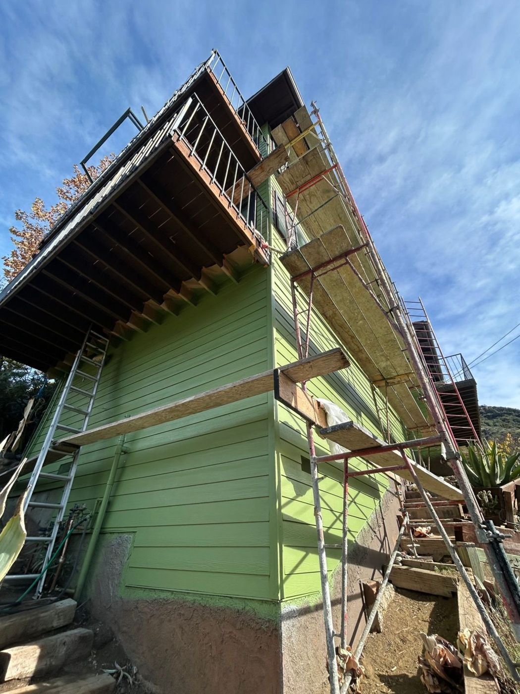 After siding replacement: fiber cement lap siding finished and painted, stucco base kept, corners trimmed