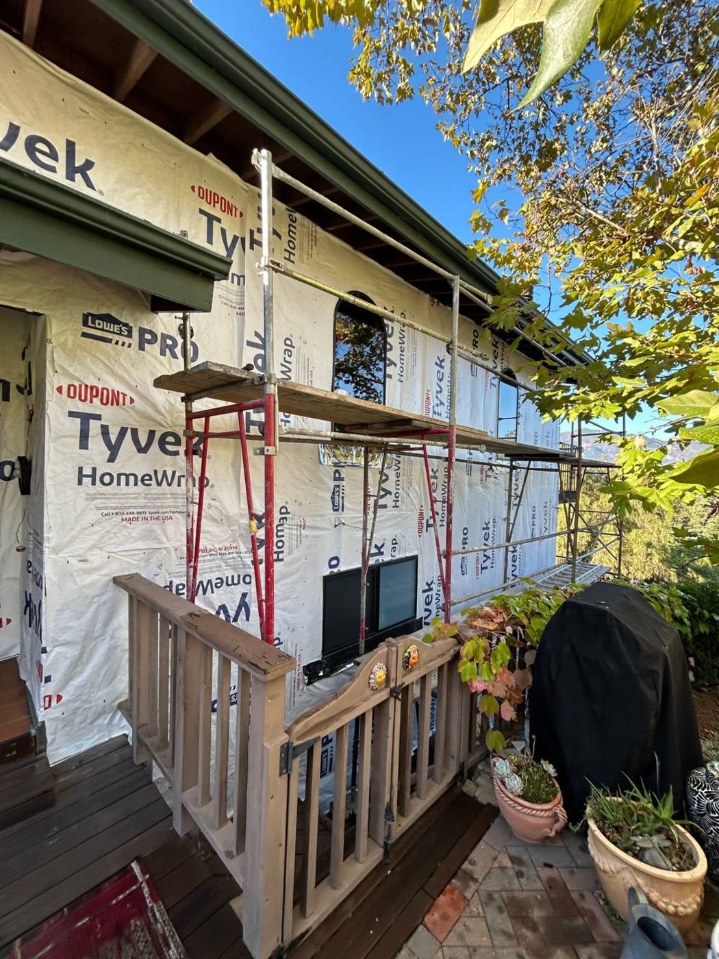 Weather-resistive barrier taped around an arched entry window before the fiber cement siding went on