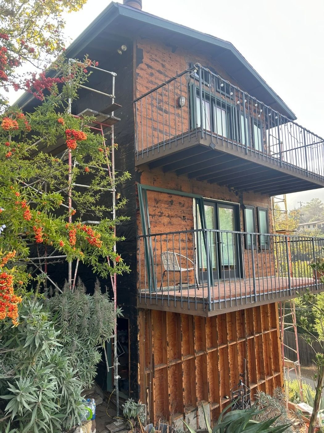 Rear elevation with the siding removed around the deck ledgers so the flashing could be done right